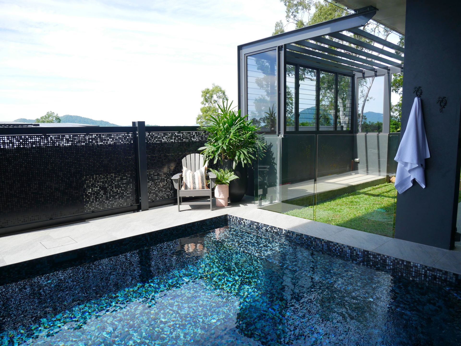 There Is a Large Swimming Pool in The Backyard of A House — Pools Plus NQ in Cairns, QLD