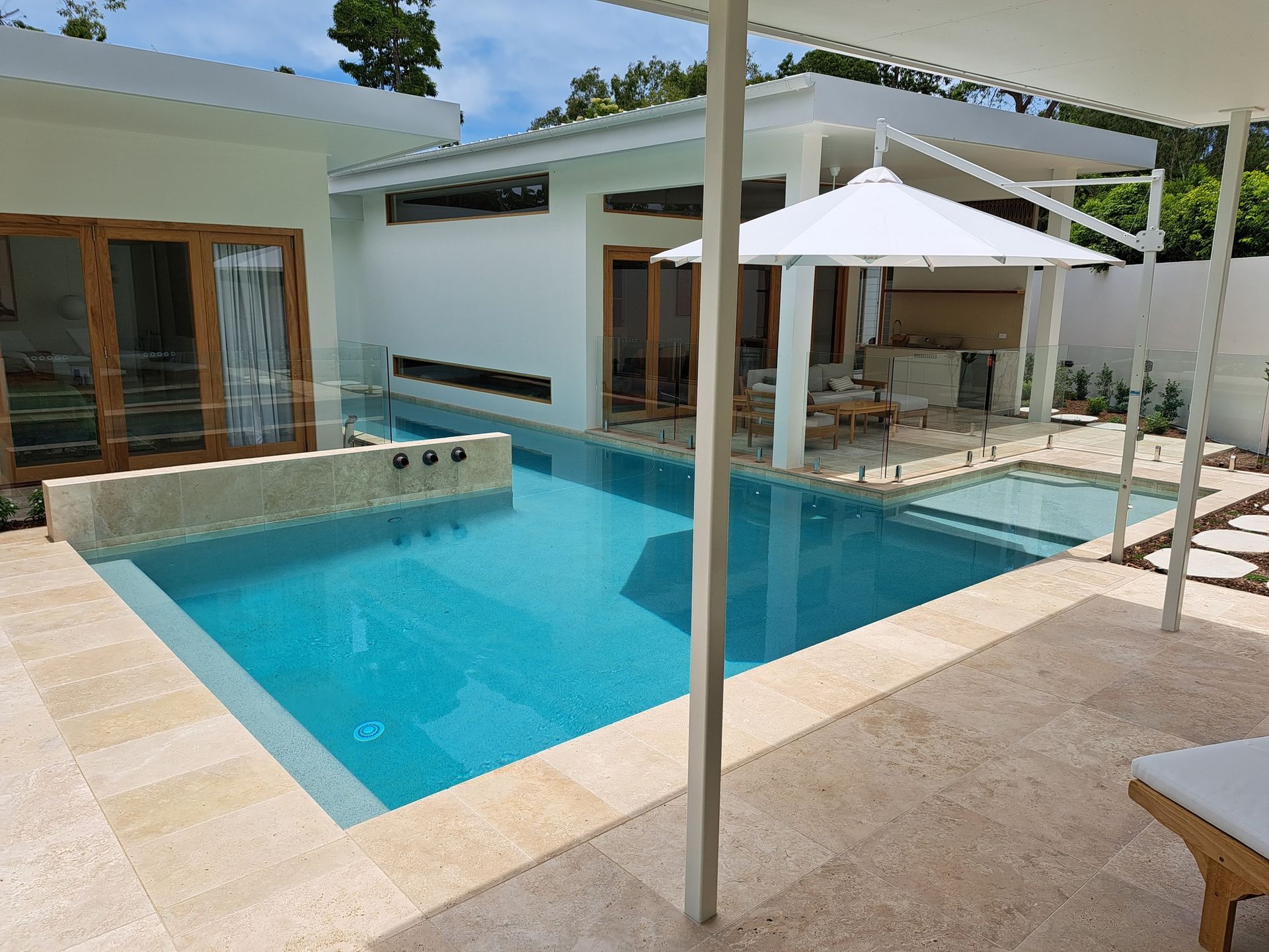 A Large Swimming Pool in The Backyard of A House — Pools Plus NQ in Kewarra Beach, QLD