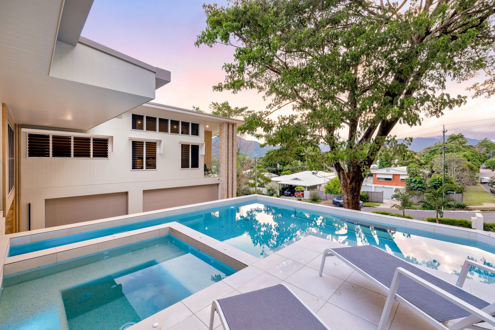 A Large Swimming Pool in The Backyard of A House — Pools Plus NQ in Kewarra Beach, QLD