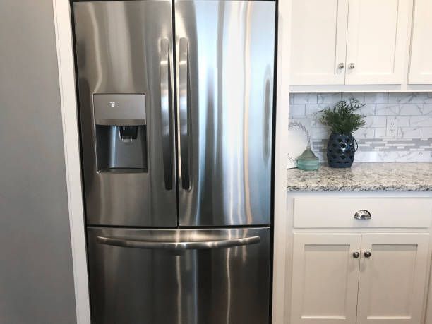 Stainless steel refrigerator in a kitchen with white cabinets | Pennsauken, NJ | H and R Appliances