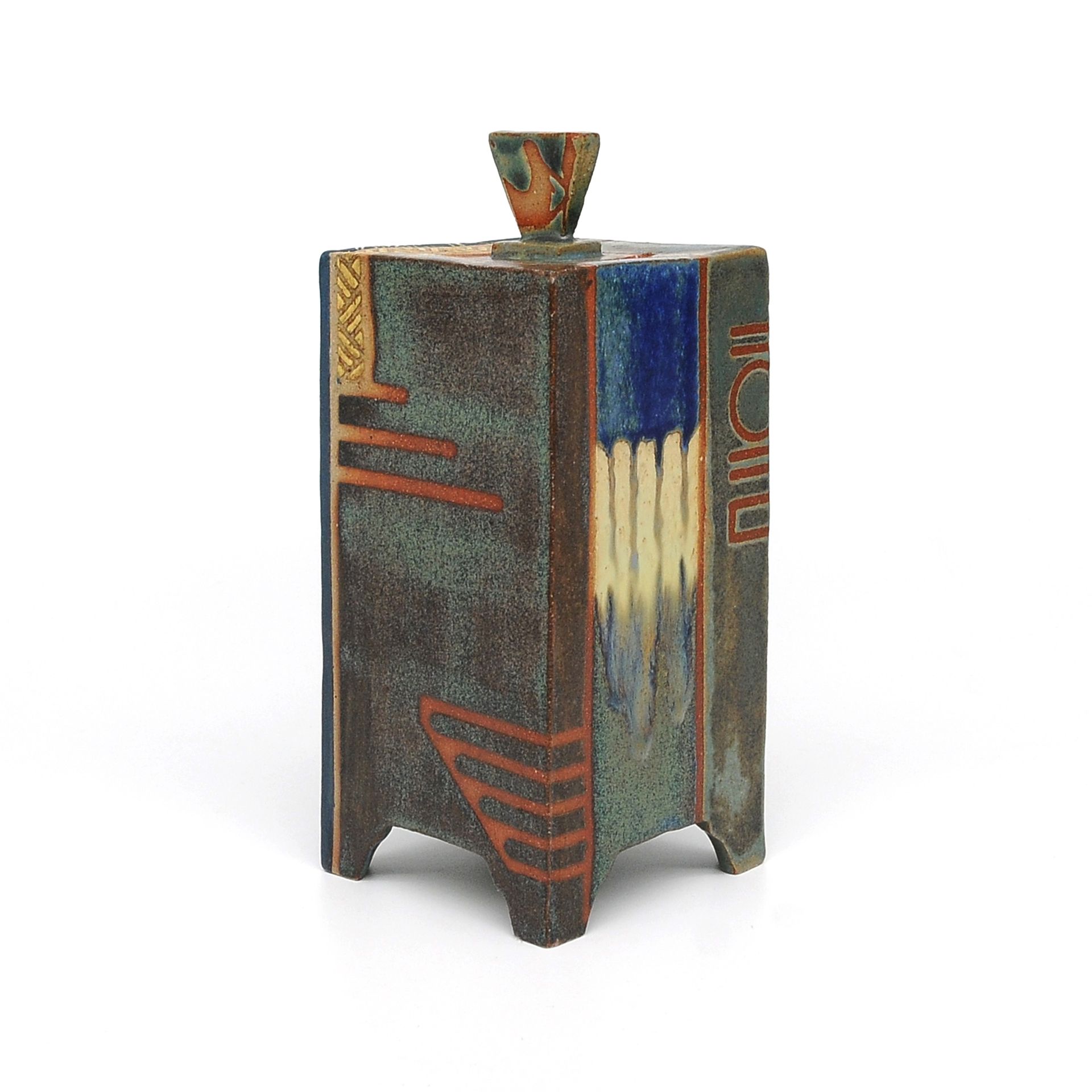 A colorful ceramic vase with a lid on a white background.