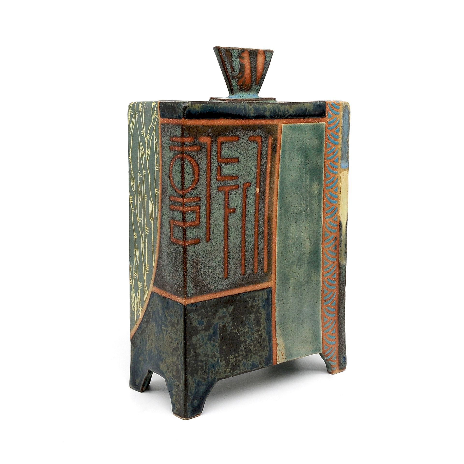 A ceramic vase with chinese writing on it