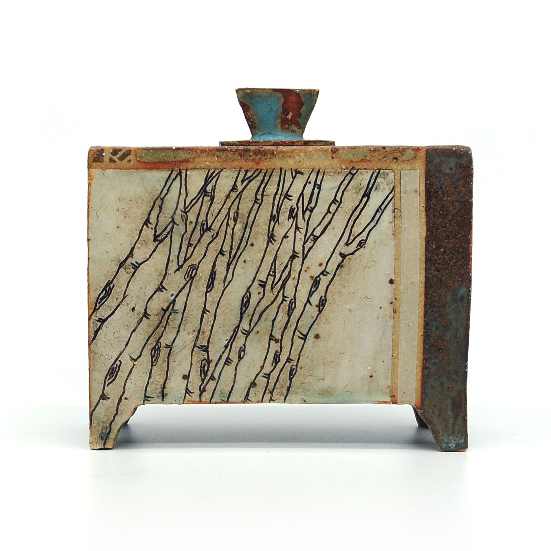 a ceramic box with a geometric design on it