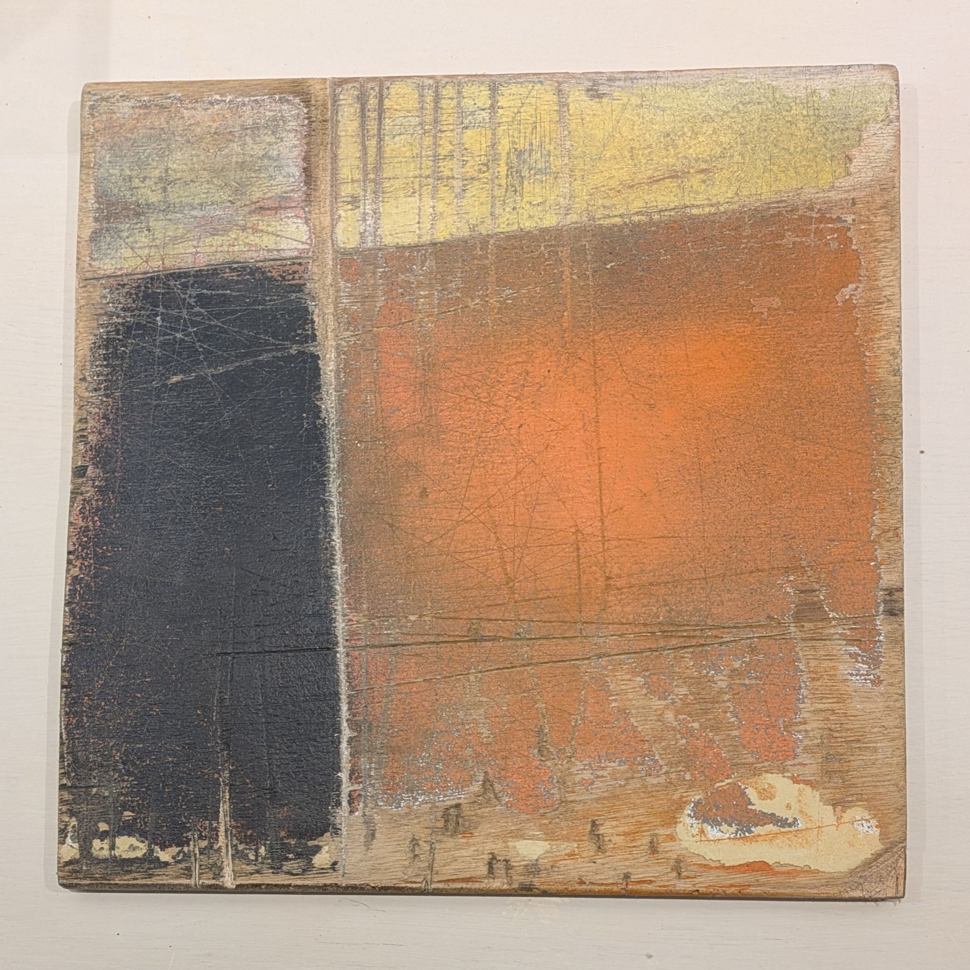 Abstract painting with a dark vertical block on the left and warm orange and yellow blocks on the right.