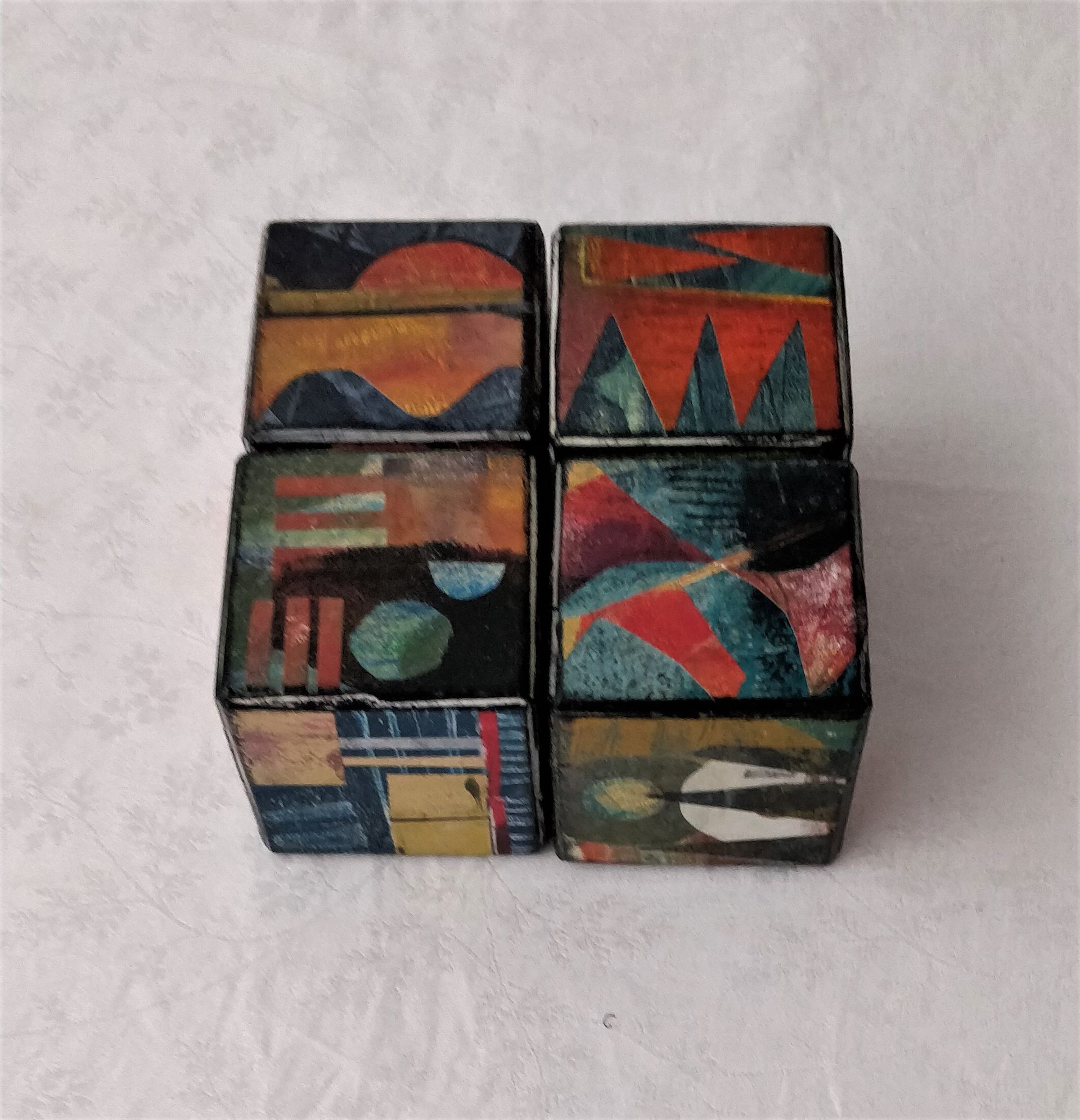 A set of four cubes with different designs on them