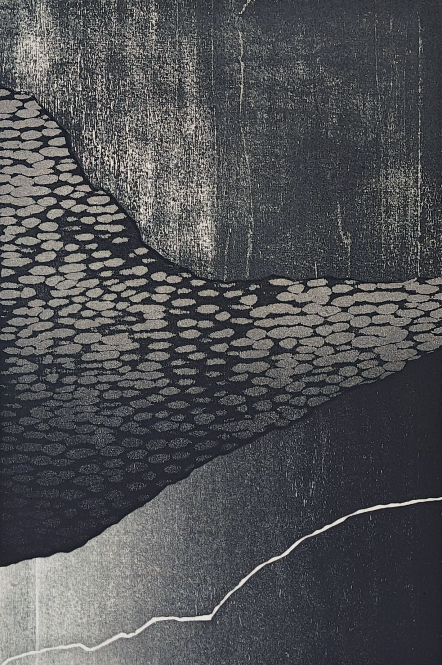 Abstract dark textured surface with a pale curved line across the lower half