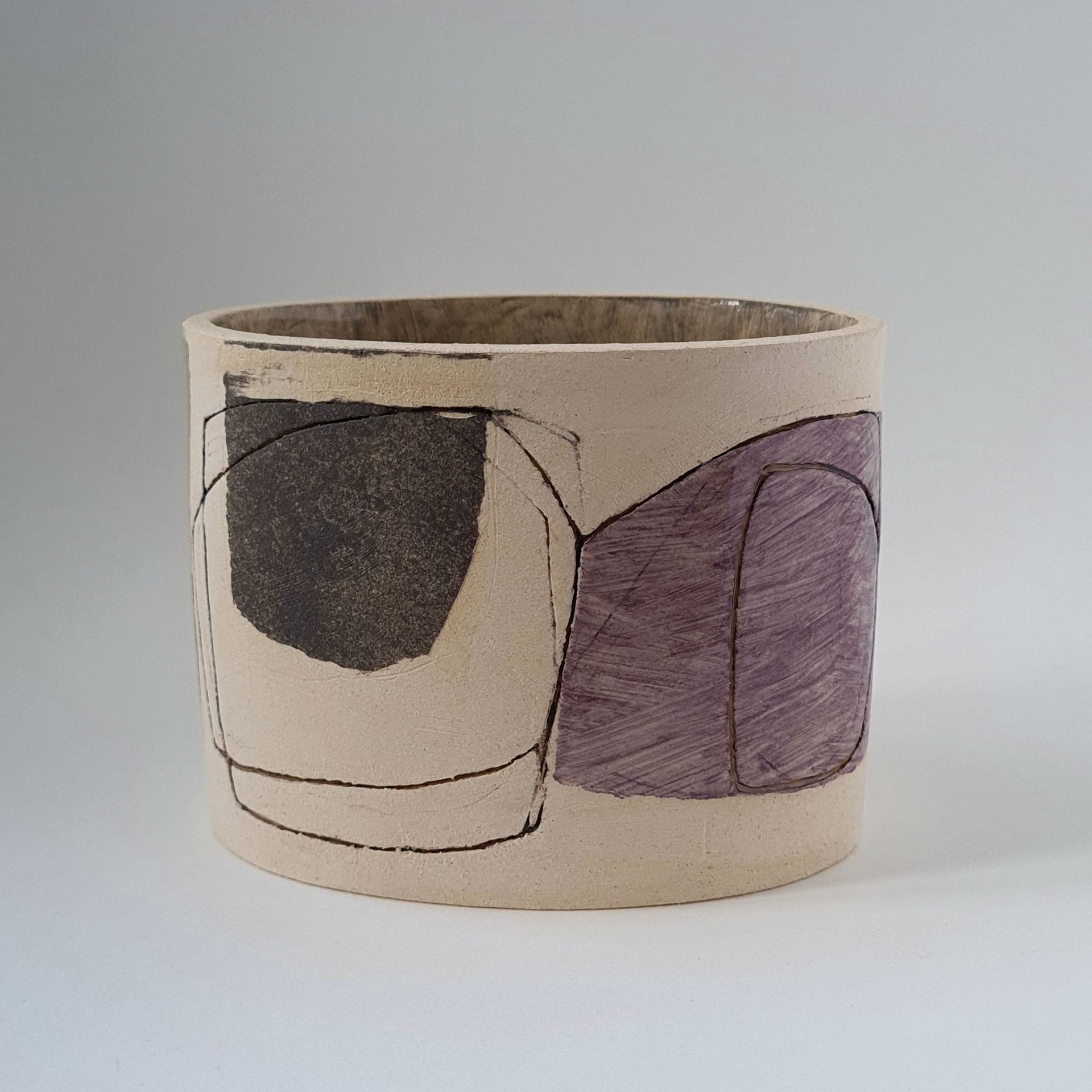 a vase with a purple and black design on it