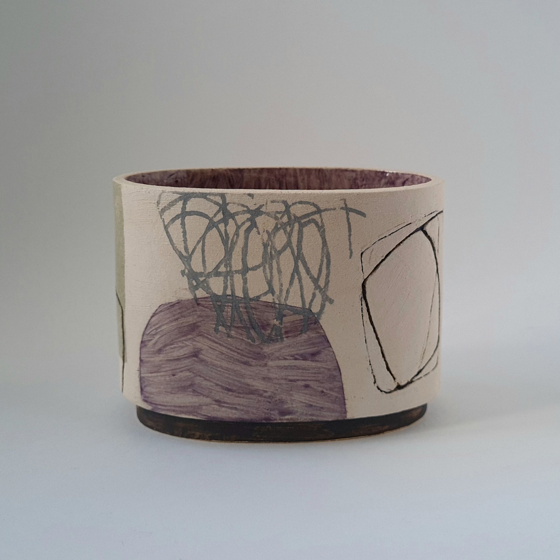 a white vase with a purple design on it