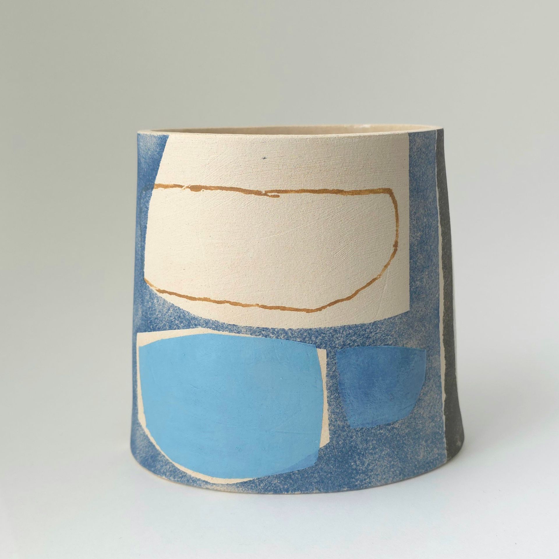 A pair of earrings are sitting on a white surface.