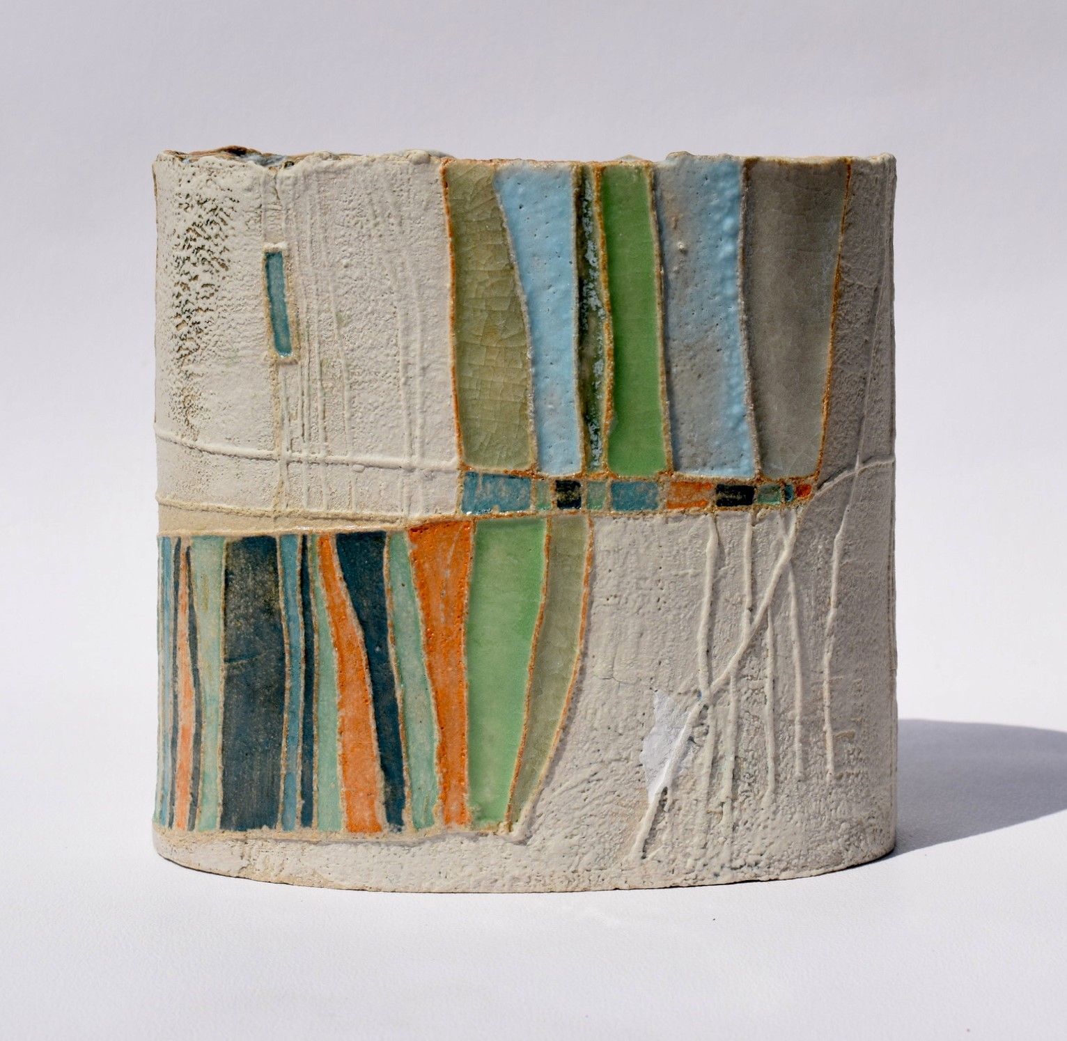a colorful ceramic sculpture with a white background