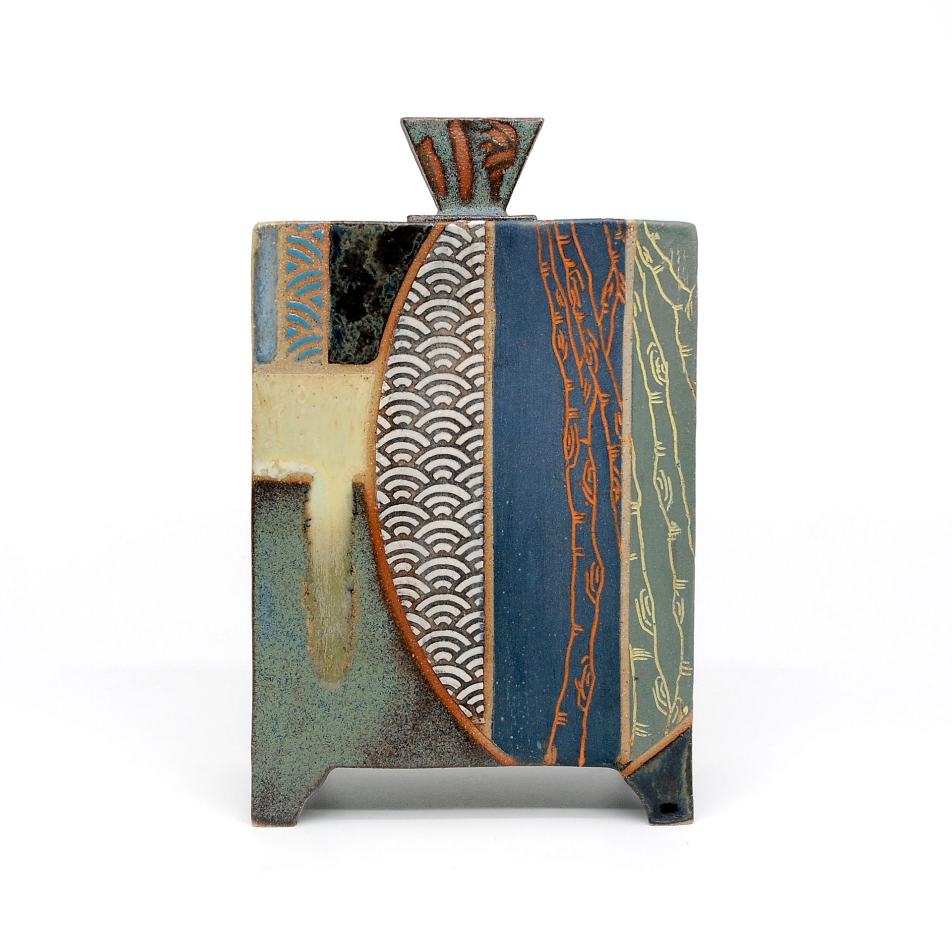 A ceramic vase with a geometric design on it