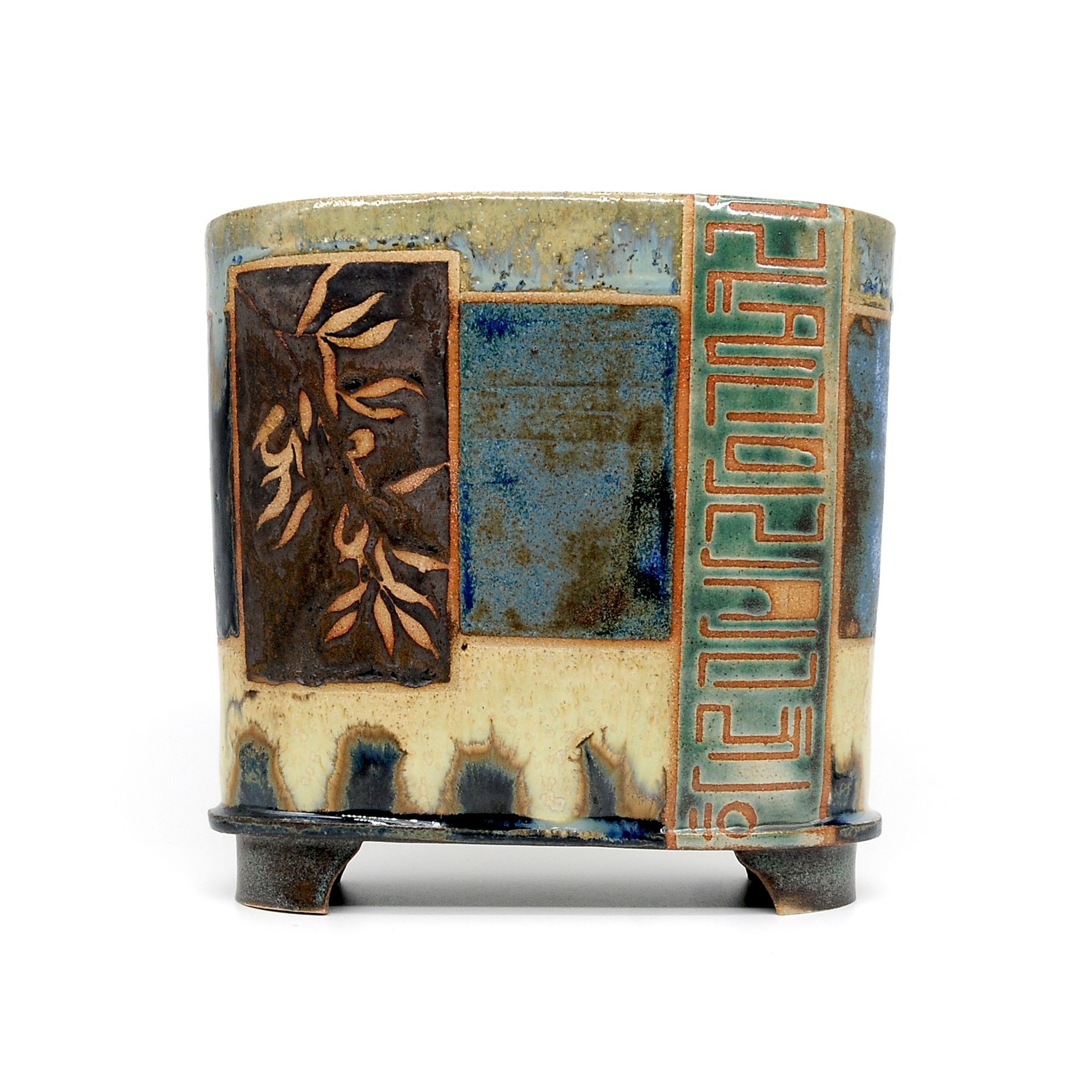 A ceramic pot with a geometric design on it