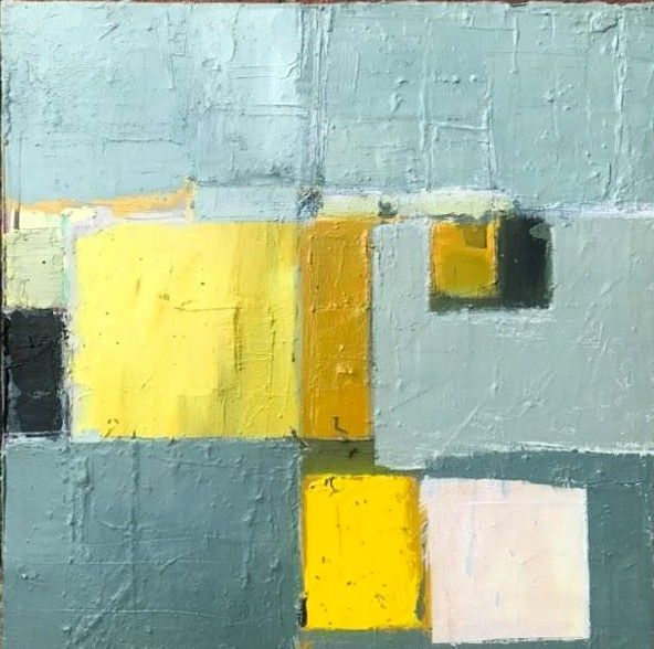 A close up of a painting of yellow and gray squares on a wall.