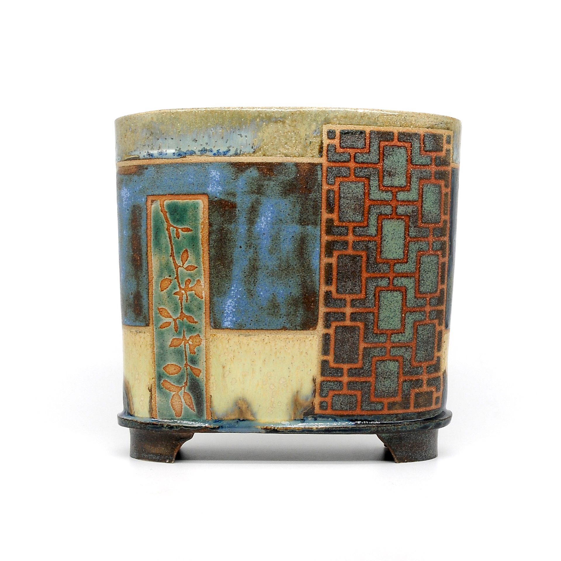 A ceramic container with a geometric pattern on it