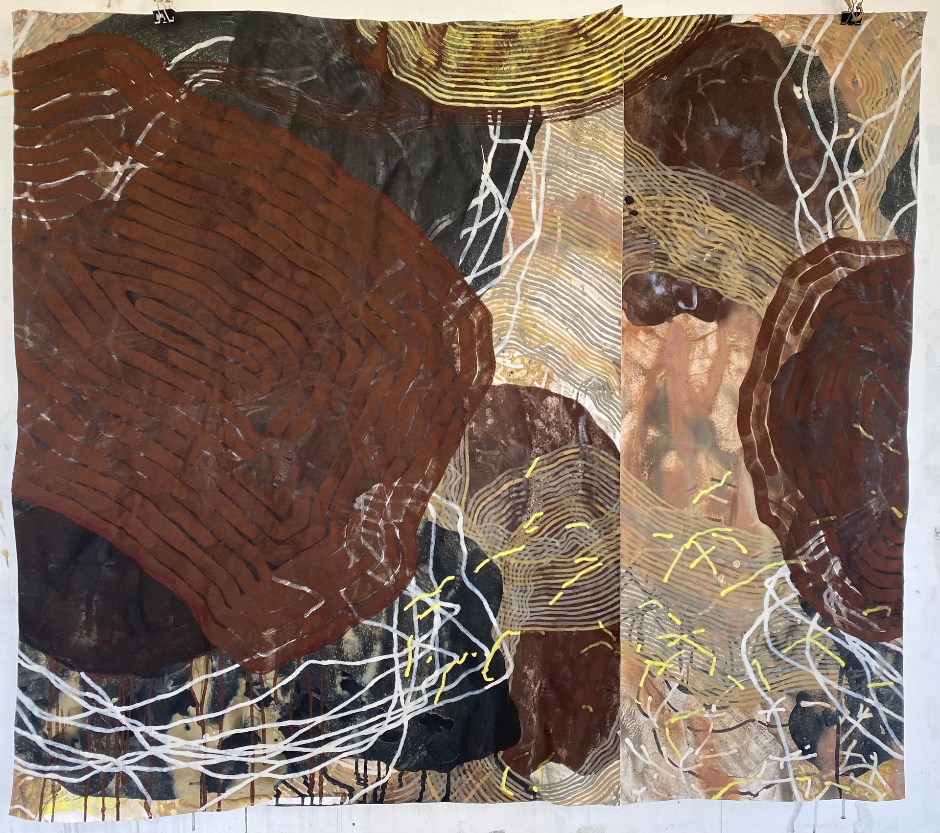 An abstract painting features large, layered brown and black organic shapes contrasted by fine, geometric golden linework.