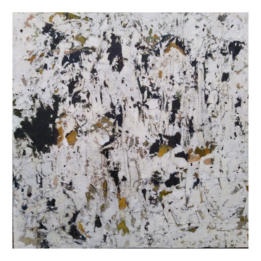 Abstract white, black, and gold paint texture with a speckled, marbled surface