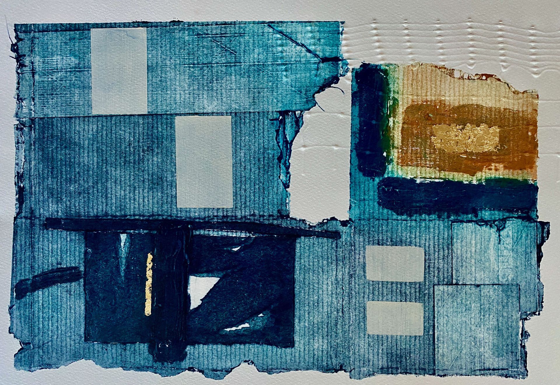Abstract blue-and-gold painted collage with geometric blocks and textured layered panels