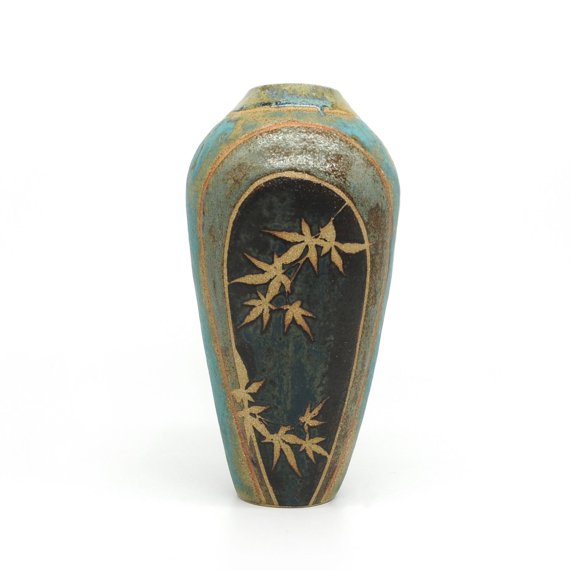 a blue vase with gold leaves on it