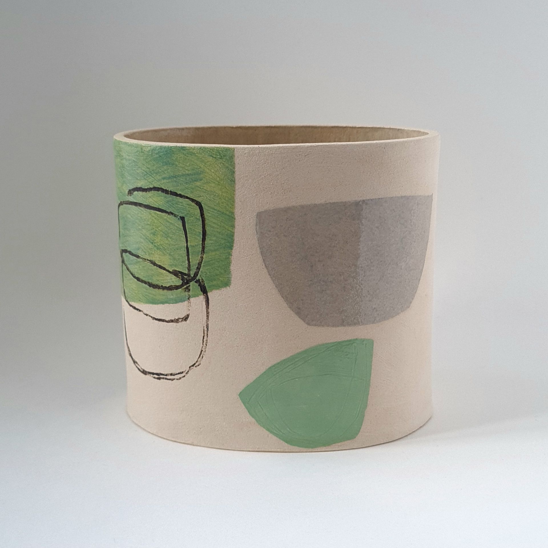 A lampshade with a green and gray design on it