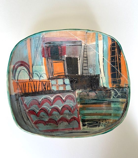 Abstract painted ceramic bowl with colorful geometric shapes and lines.