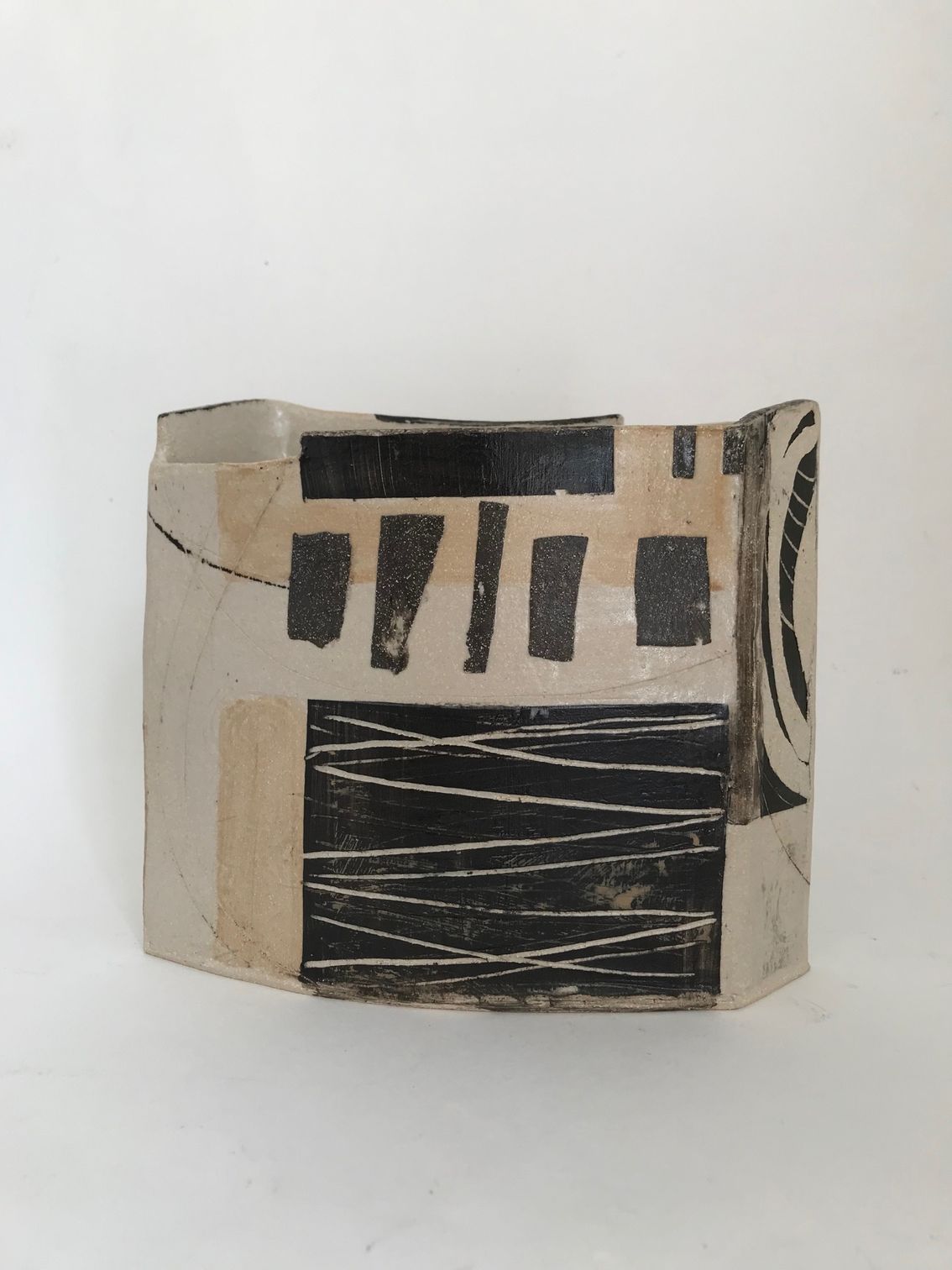 A black and white sculpture is sitting on a white surface.