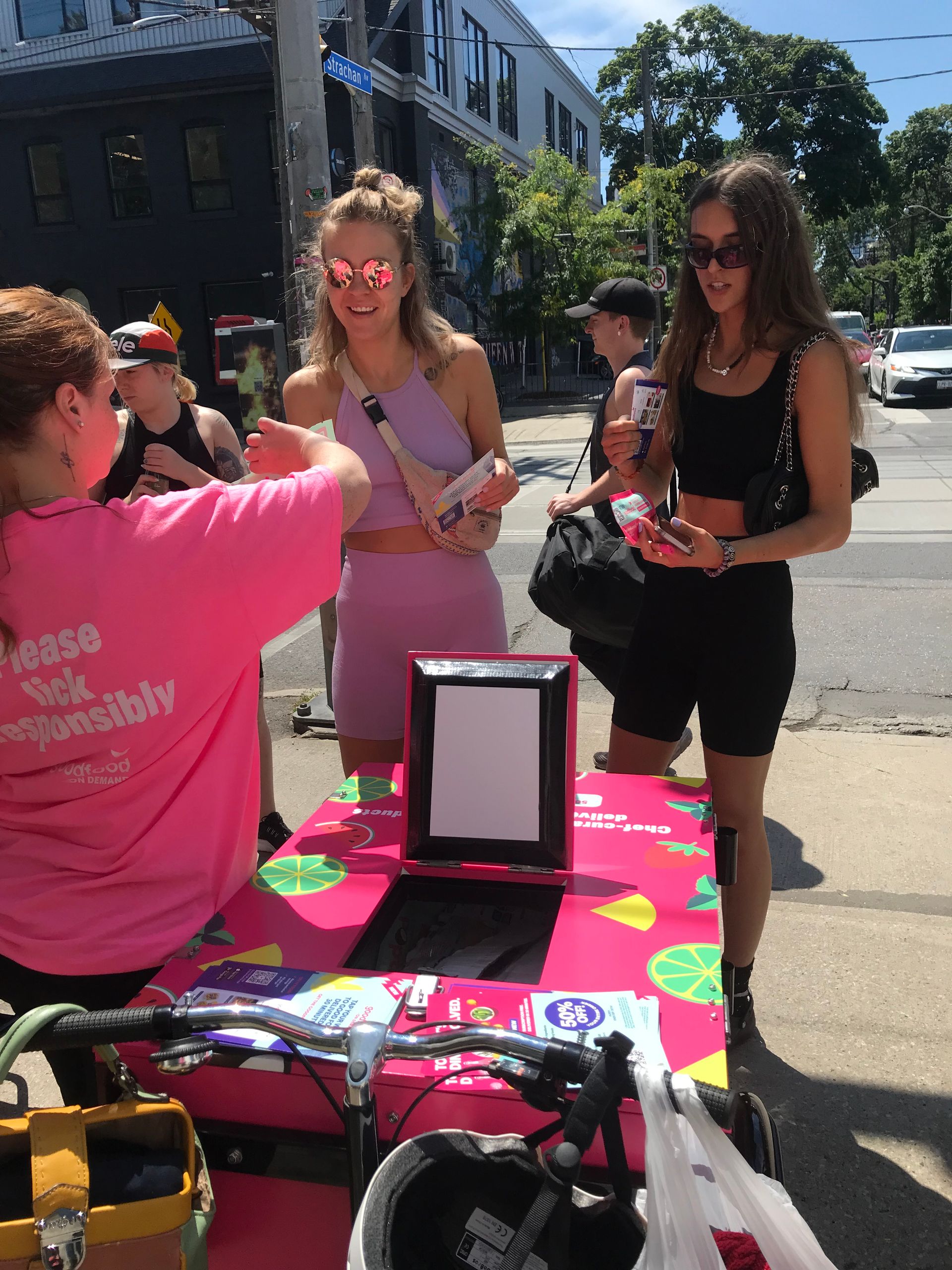 A woman wearing a pink shirt that says ' lease your visibility '