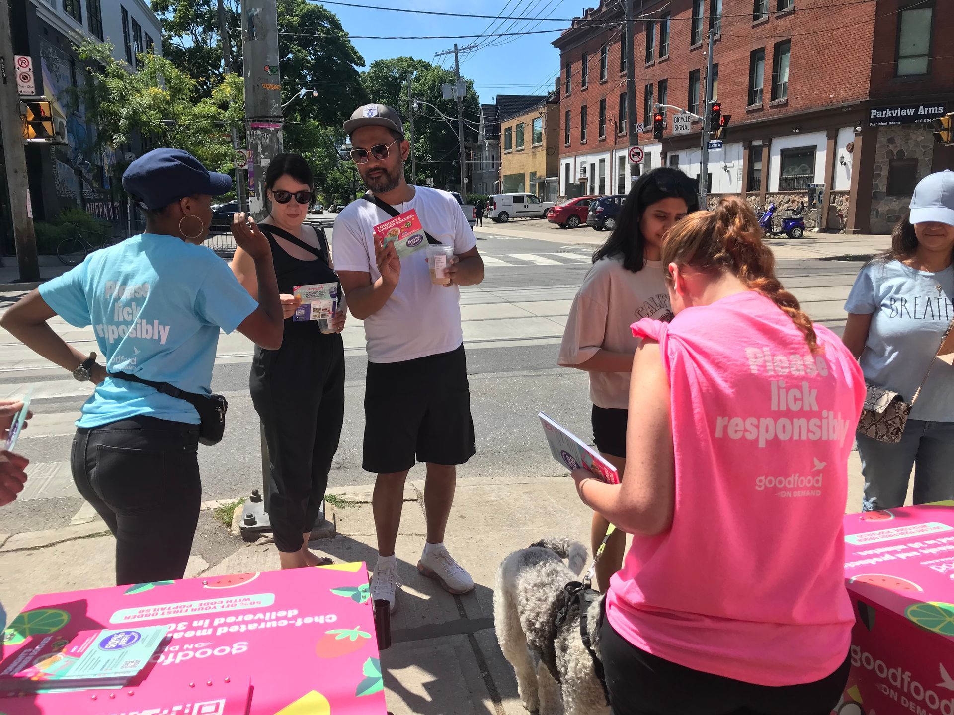 A group of people are standing around a table on the side of the road.