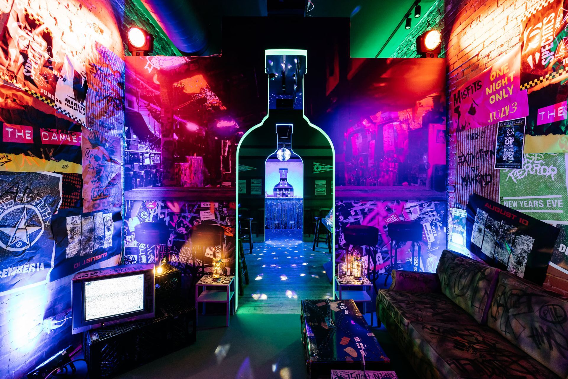 A room with a bottle of alcohol in the middle of it.