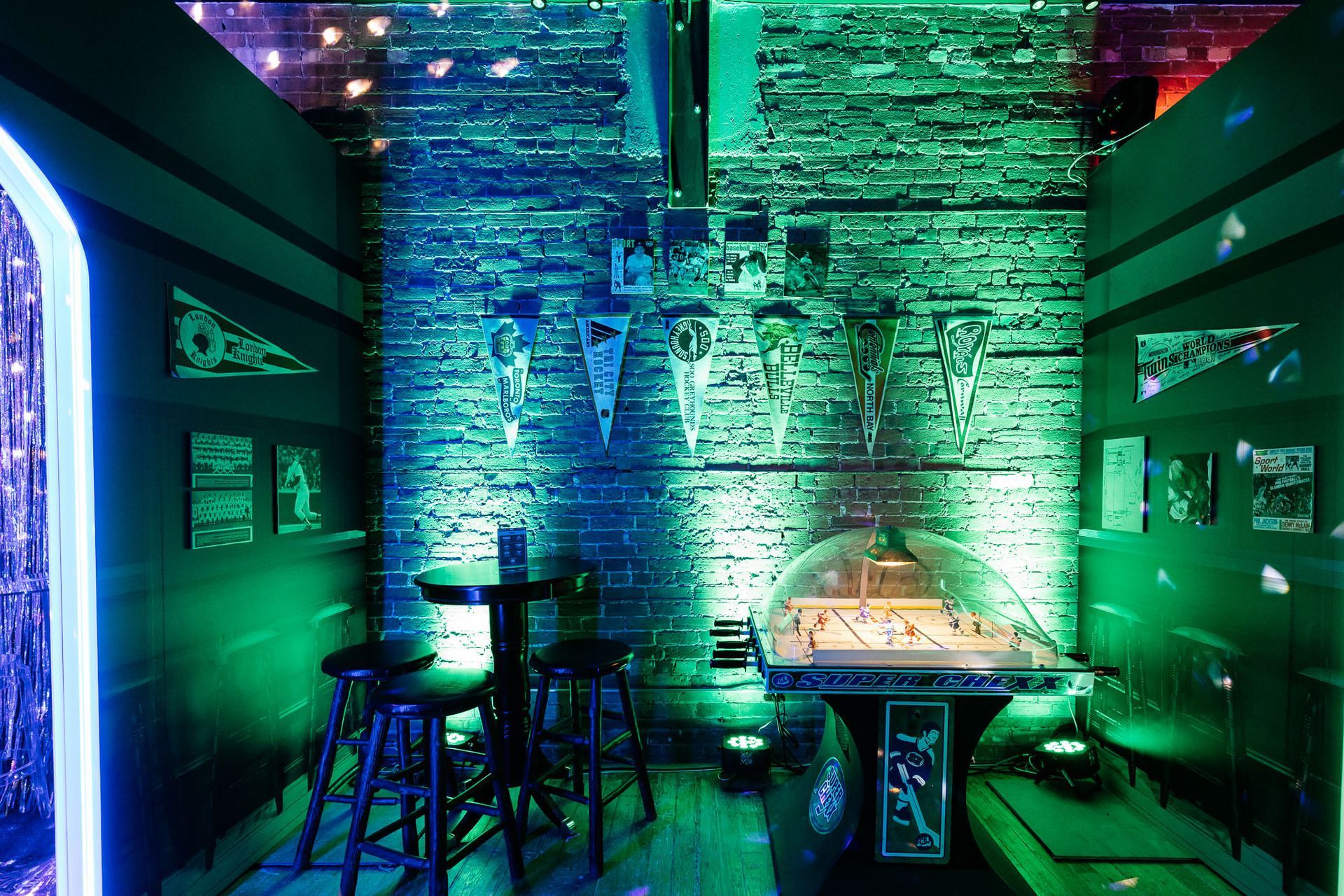 A room with a brick wall and green lights