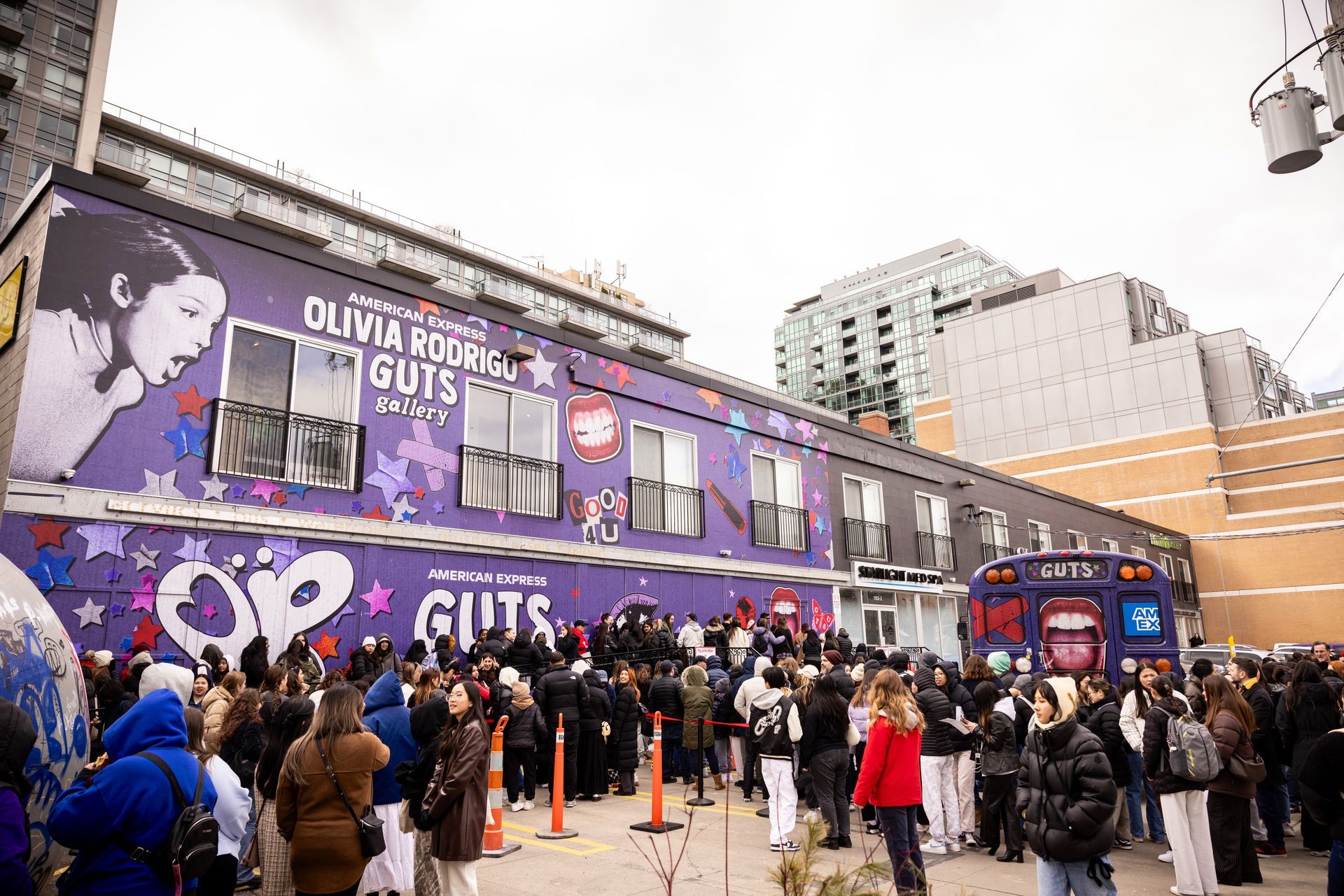 A large group of people are standing outside of a building.