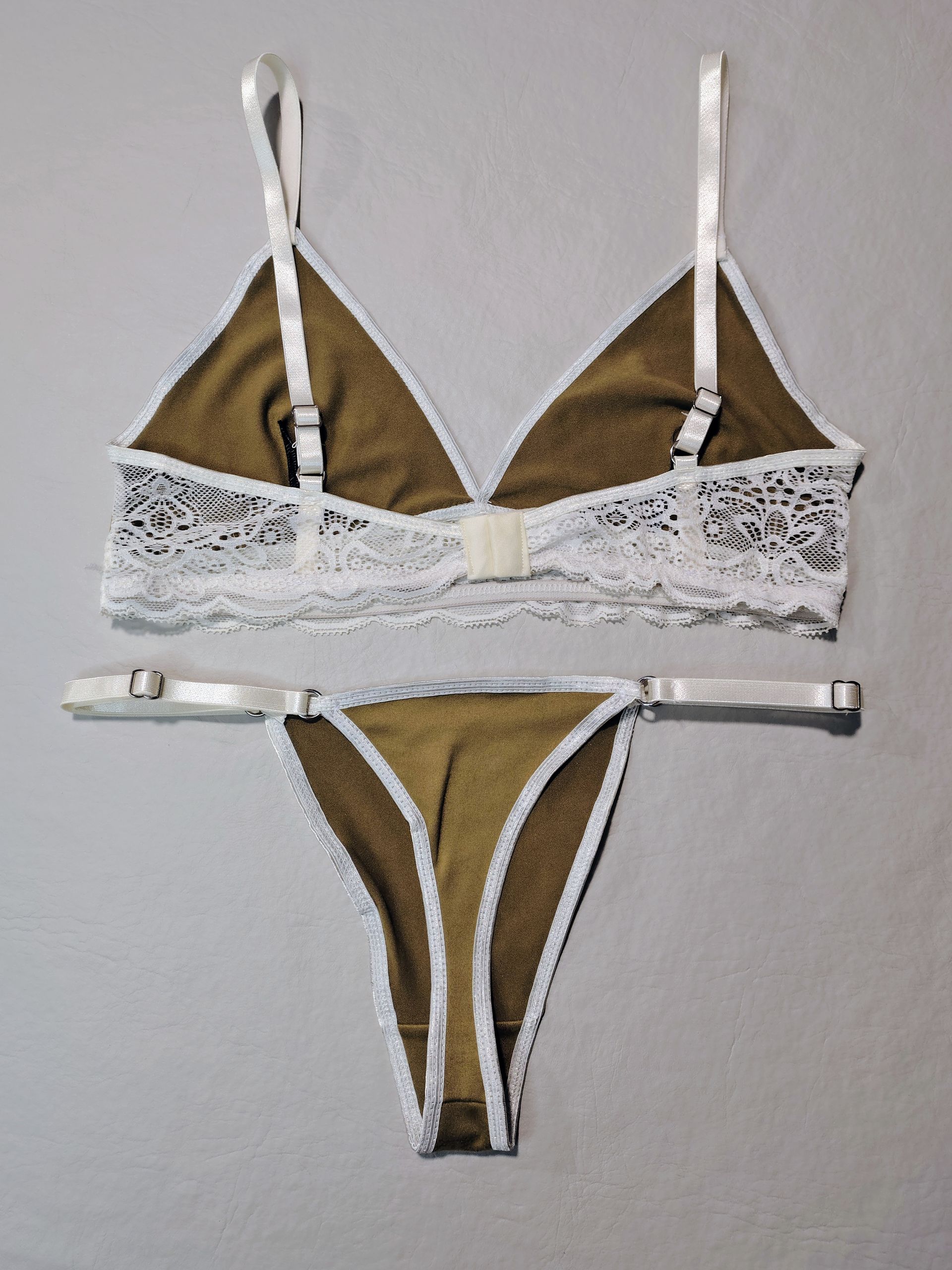 Conjunto de lencería marrón y blanco: sujetador triangular y tanga con ribete de encaje blanco.