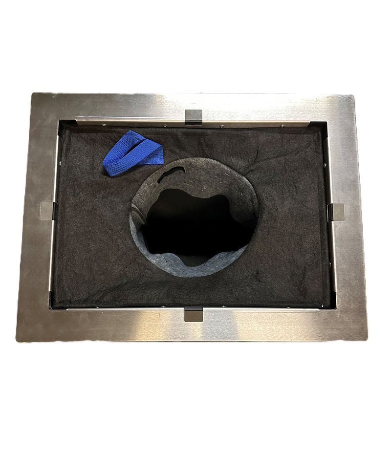 Rectangular metal frame with a dark hole in the center, surrounded by black fabric; blue cloth inside.