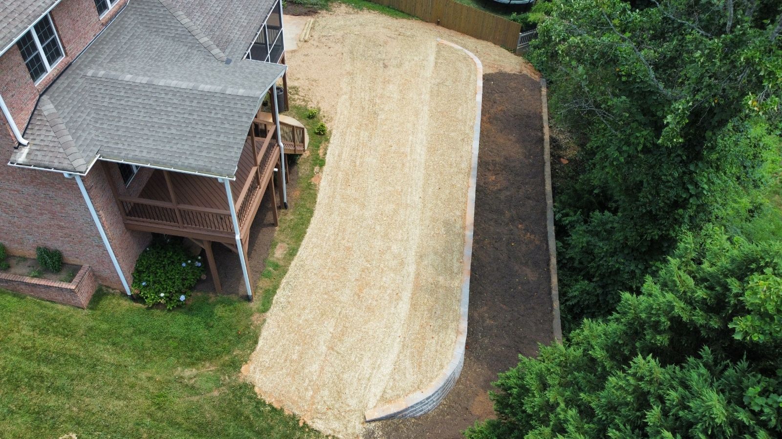 A stone wall with stairs leading up to a house.