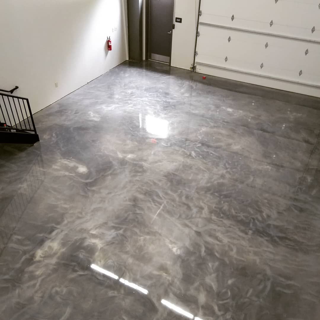 a garage with a metallic floor and a staircase .