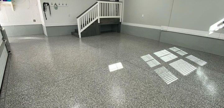 a garage with a staircase and a shiny floor .