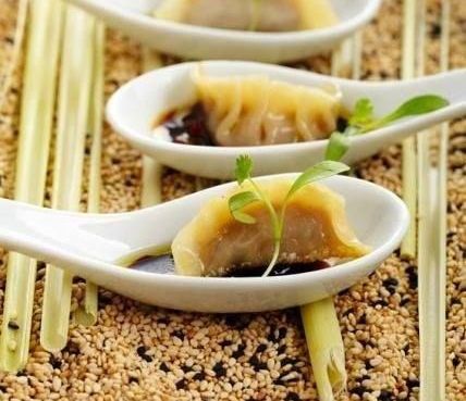 Three Spoons Filled With Dumplings and Sauce on a Table — The Larder Byron Bay in Byron Bay, NSW