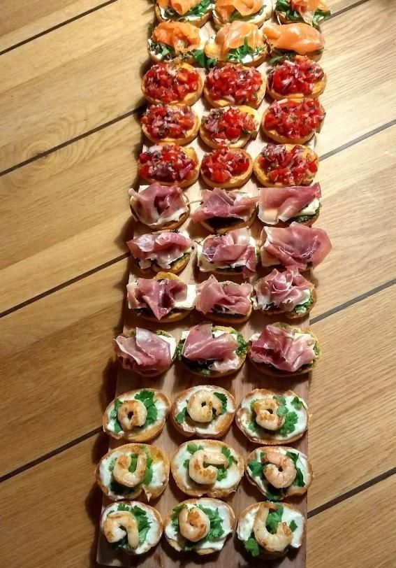 A Row of Sandwiches With Different Toppings on a Wooden Table — The Larder Byron Bay in Byron Bay, NSW