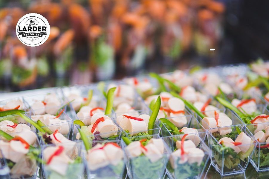 A Buffet Table Topped With a Variety of Appetizers in Plastic Cups — The Larder Byron Bay in Byron Bay, NSW