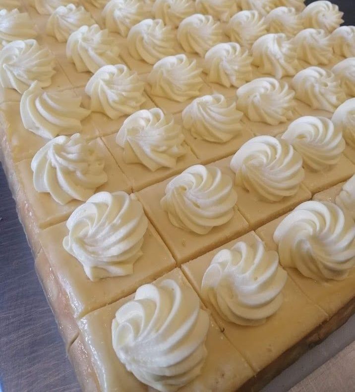 A Bunch of Pieces of Cake With Whipped Cream on Them — The Larder Byron Bay in Byron Bay, NSW