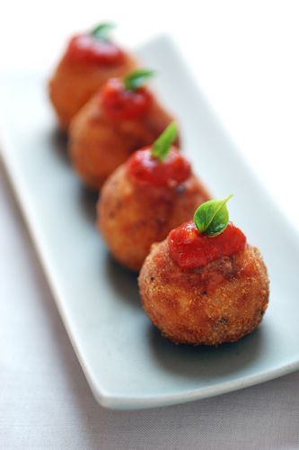 A Row of Food Balls on a Plate With Tomato Sauce on Top — The Larder Byron Bay in Byron Bay, NSW