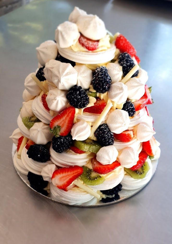 A Cake With Meringue and Fruit on Top of It — The Larder Byron Bay in Byron Bay, NSW