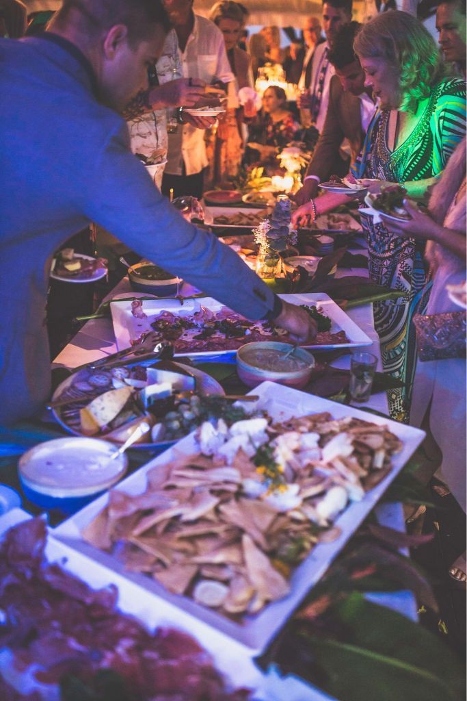 A Man is Serving Food to a Crowd of People at a Buffet Table — The Larder Byron Bay in Byron Bay, NSW
