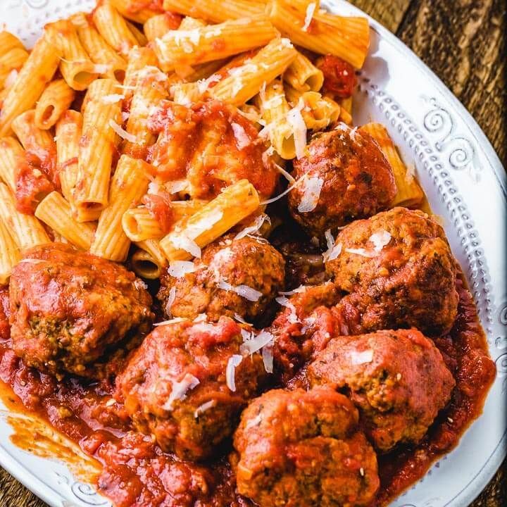 A Plate of Pasta and Meatballs With Sauce on a Wooden Table — The Larder Byron Bay in Byron Bay, NSW