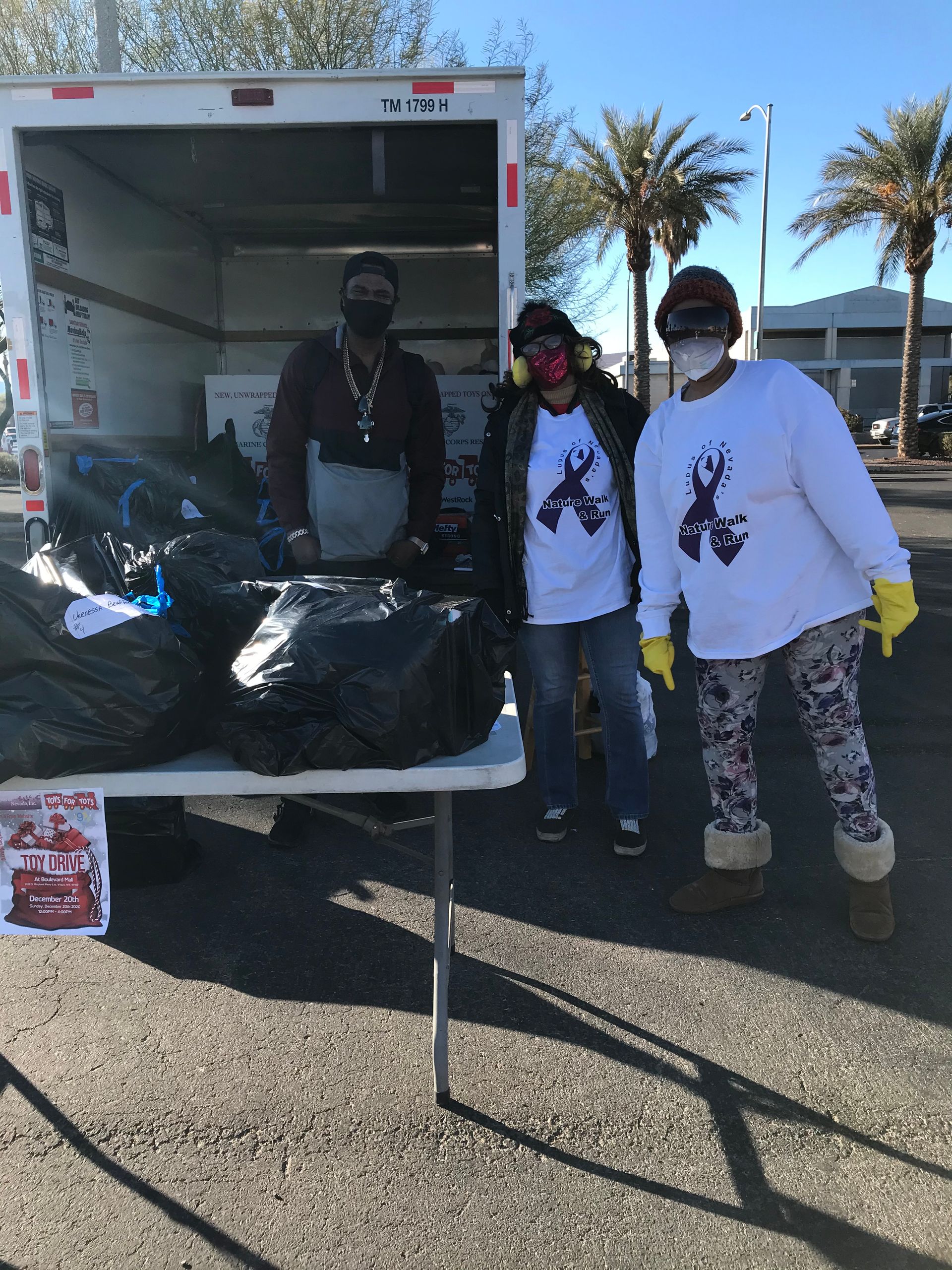 Group of diverse people posing together indoors, smiling.