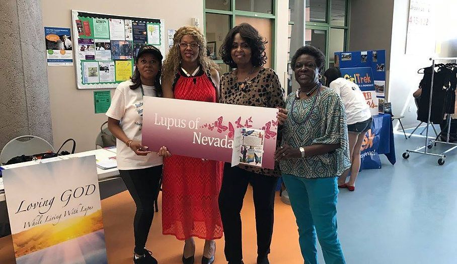 Four people holding a