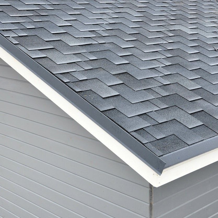 A close up of a roof with shingles on a house.