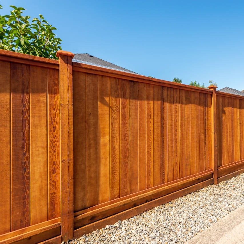 A wooden fence with a blue sky in the background