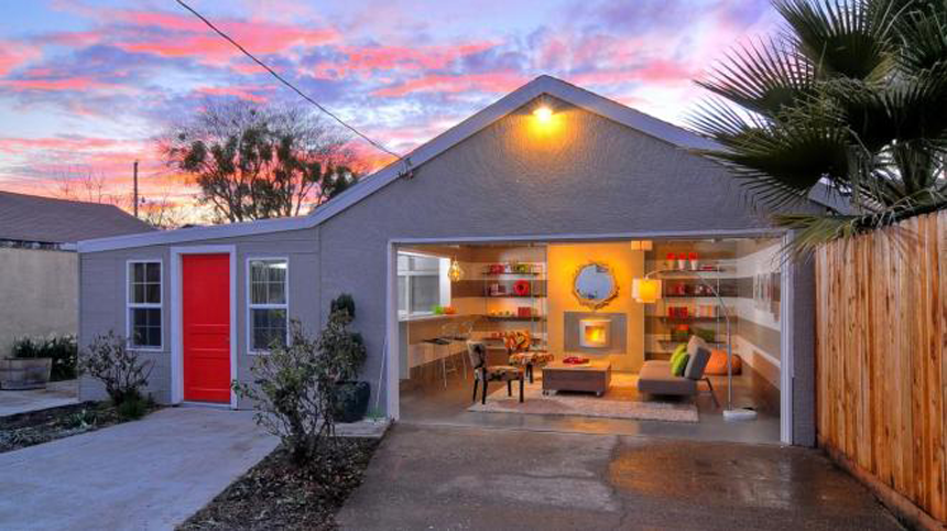 A house with a garage and a red door