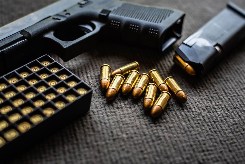 Close Up Photo Of Gun And Bullets — Glen Burnie, MD — The Law Offices Of Fischer & Putzi, P.A.