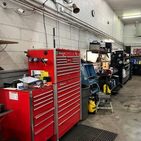 A garage with a lot of tools and a red toolbox
